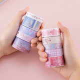 Tsuki ‘Sakura Journey’ Washi Tape Set held in hands in light pink background
