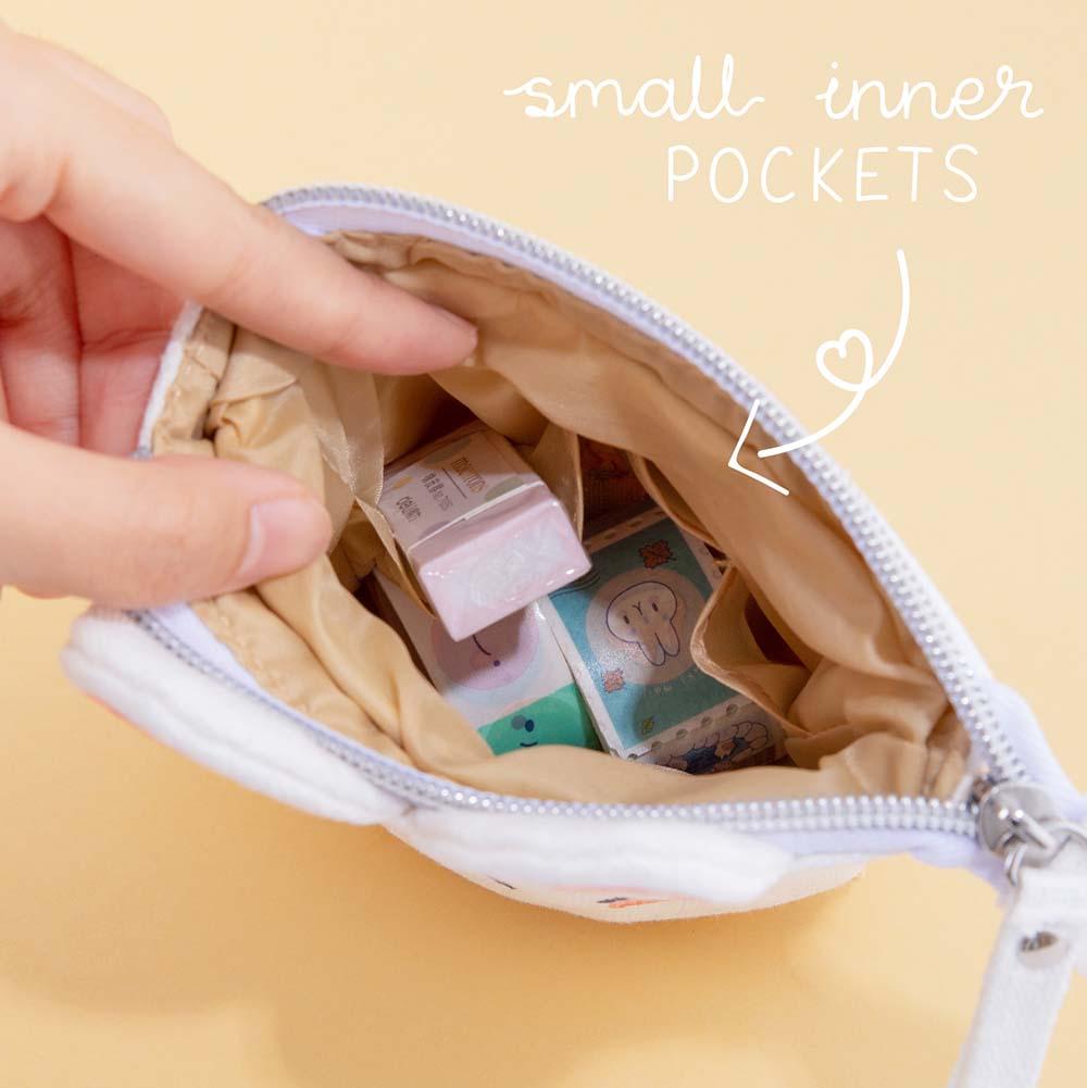Close up of open Tsuki ‘Four Seasons’ Embroidered Pop-Up Pencil Case by Notebook Therapy x Milkkoyo with small inner pockets held in hand on honey yellow background