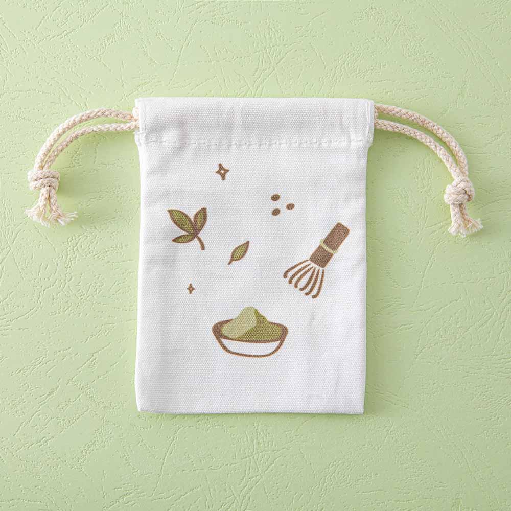 Close up of the Tsuki ‘Matcha Matcha’ Tote Bag free matching drawstring pouch on matcha green background