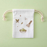 Close up of the Tsuki ‘Matcha Matcha’ Tote Bag free matching drawstring pouch on matcha green background