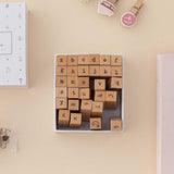 Tsuki Bullet Journal Typewriter Style Alphabet Stamps with eco-friendly gift box packaging on beige background