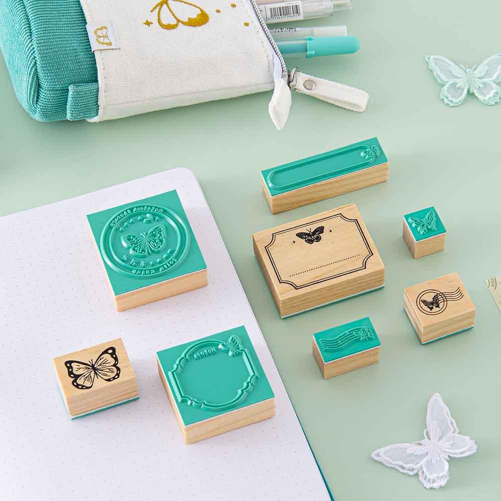 Tsuki ‘Flutter + Dream’ Bullet Journal Stamp Set by Notebook Therapy x Pelinkan on open Tsuki Teal Sky ‘Flutter + Dream’ Limited Edition Bullet Journal by Notebook Therapy x Pelinkan with Tsuki ‘Flutter + Dream’ Pop-Up Pencil Case by Notebook Therapy x Pelinkan in teal with butterflies on mint background