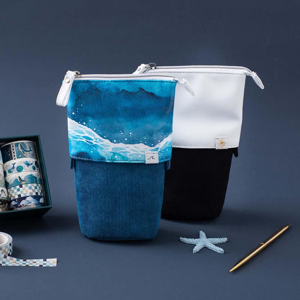Tsuki Ocean Edition pop up standing pencil cases in Orca Black and Ocean Blue with Tsuki Ocean Washi Tape and and pen and starfish in dark blue background