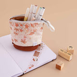 Tsuki ‘Maple Dreams’ Pop-Up Pencil case with pens inside on Tsuki ‘Nara’ Limited Edition Bullet Journal with Tsuki ‘Maple Dreams’ Washi Tape and Tsuki ‘Maple Dreams Bullet Journal stamps on beige background