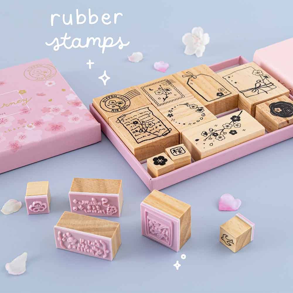 Tsuki ‘Sakura Journey’ Bullet Journal Stamp Set with rubber stamps with cherry blossom petals on light blue background