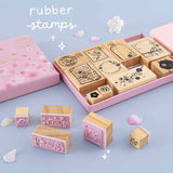 Tsuki ‘Sakura Journey’ Bullet Journal Stamp Set with rubber stamps with cherry blossom petals on light blue background