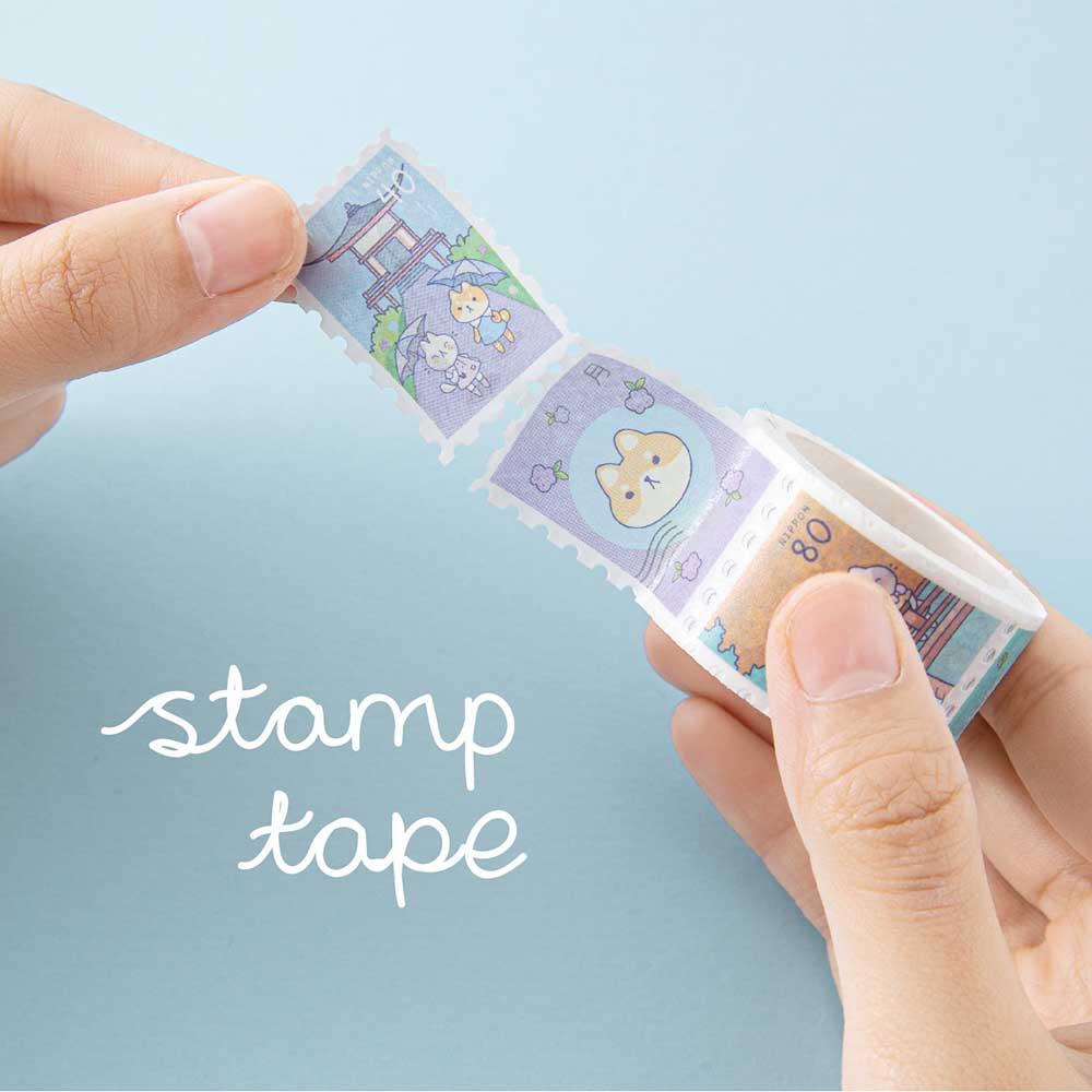 Tsuki ‘Four Seasons’ Stamp Washi Tape by Notebook Therapy x Milkkoyo held in hands in light blue background