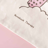 Close up of Tsuki ‘Ichigo’ Boba Tote Bag matcha design with Notebook Therapy logo on light pink background
