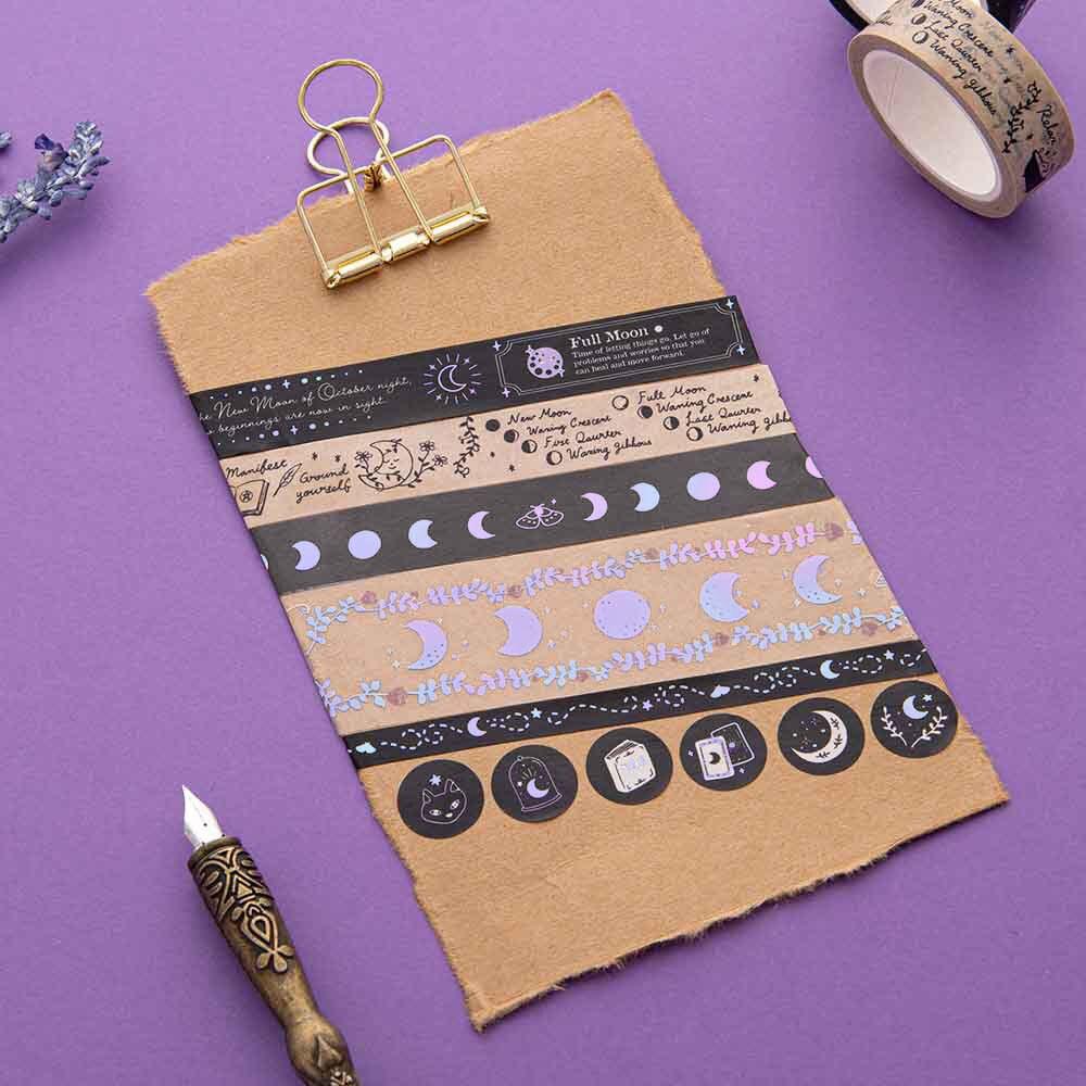 Tsuki ‘Moonlit Spell’ Washi Tape Set on kraft paper clipboard with lavender sprigs and black feather quill on purple background