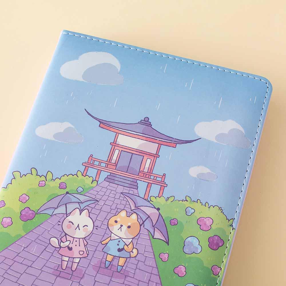 Close up of Tsuki Four Seasons: Summer Edition Bullet Journal designed with @milkkoyo on open page on honey yellow background