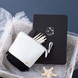 Tsuki Ocean Edition pop up standing pencil case in Orca Black with deep black vegan leather Playful Orca limited edition notebook in basket with pens and starfish in dark blue background