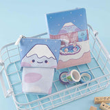 Tsuki ‘Four Seasons’ Fuji Pop-Up Pencil Case by Notebook Therapy x Milkkoyo with Tsuki ‘Four Seasons: Winter Edition’ Bullet Journal and Tsuki ‘Four Seasons’ Washi Tapes in white basket with Tsuki ‘Four Seasons’ Bullet Journal stamps on light blue background