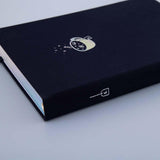Close up of Tsuki ‘Cup of Galaxy’ Limited Edition Holographic Bullet Journal on light blue background