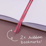 Close up of Tsuki ‘Vintage Rose’ Limited Edition Bullet Journal with two bookmark ribbons on mauve background