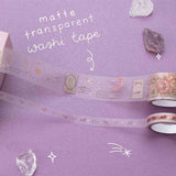 Close up of Tsuki ‘Moonlit Blush’ matte transparent washi tape with amethyst stones on purple background