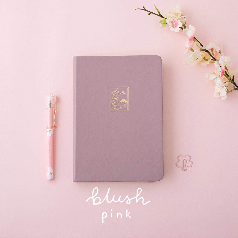 Tsuki 'Sakura' Limited Edition Bullet Journal in blush pink with pink pen and flower branch on light pink background