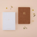 Flatlay of tsuki kuma brown velvet bear bullet journal with the recyclable gift box