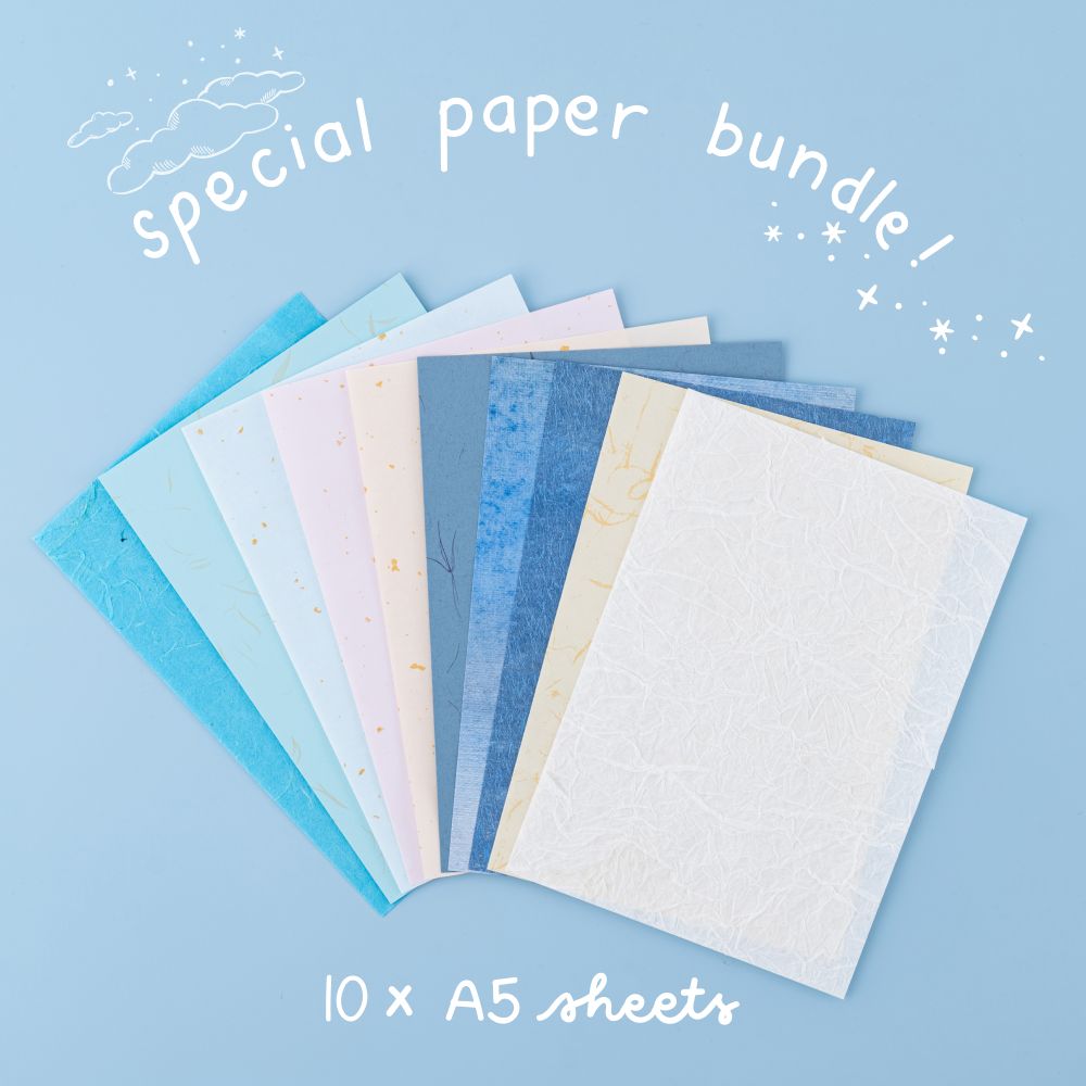 Flatlay of special paper bundle in different colours with gold foil details