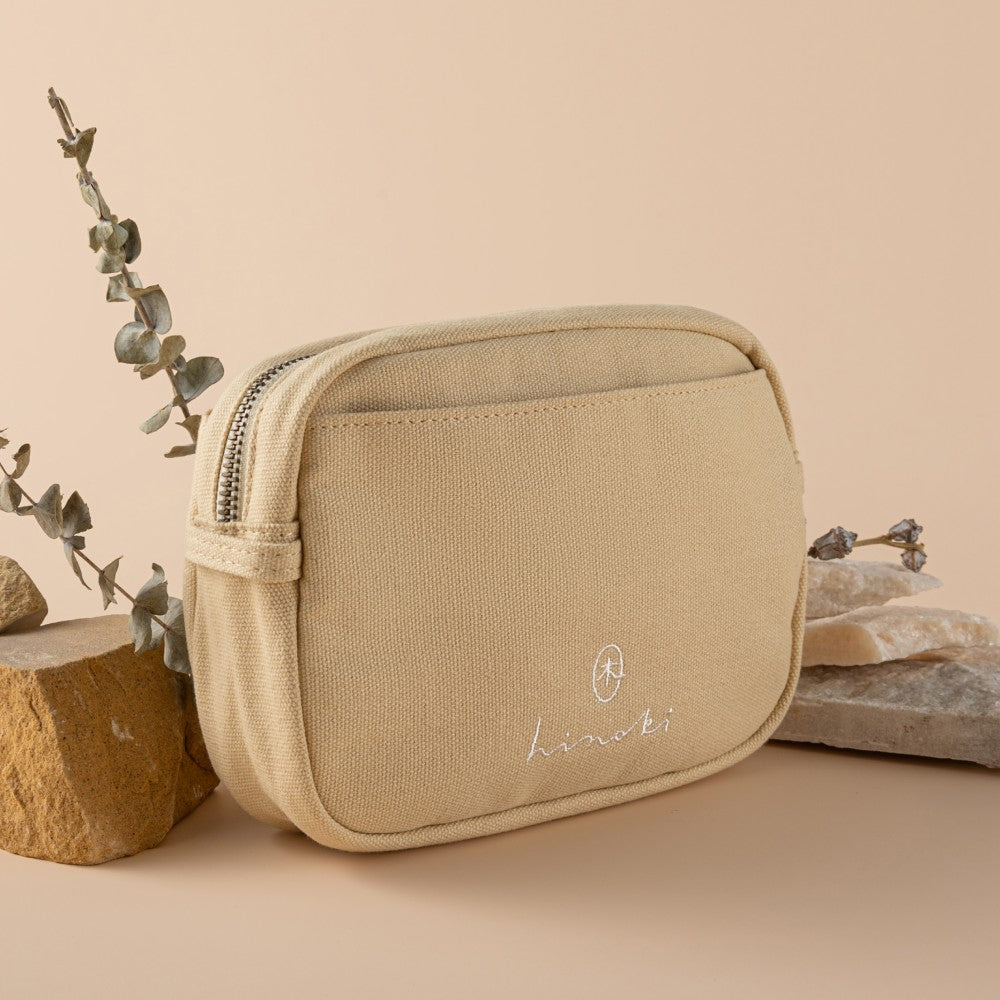 Angled photo of cream hinoki travel pouch