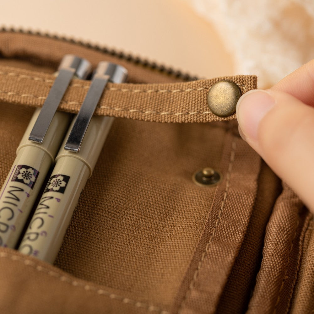 Close up of secure strap for pens