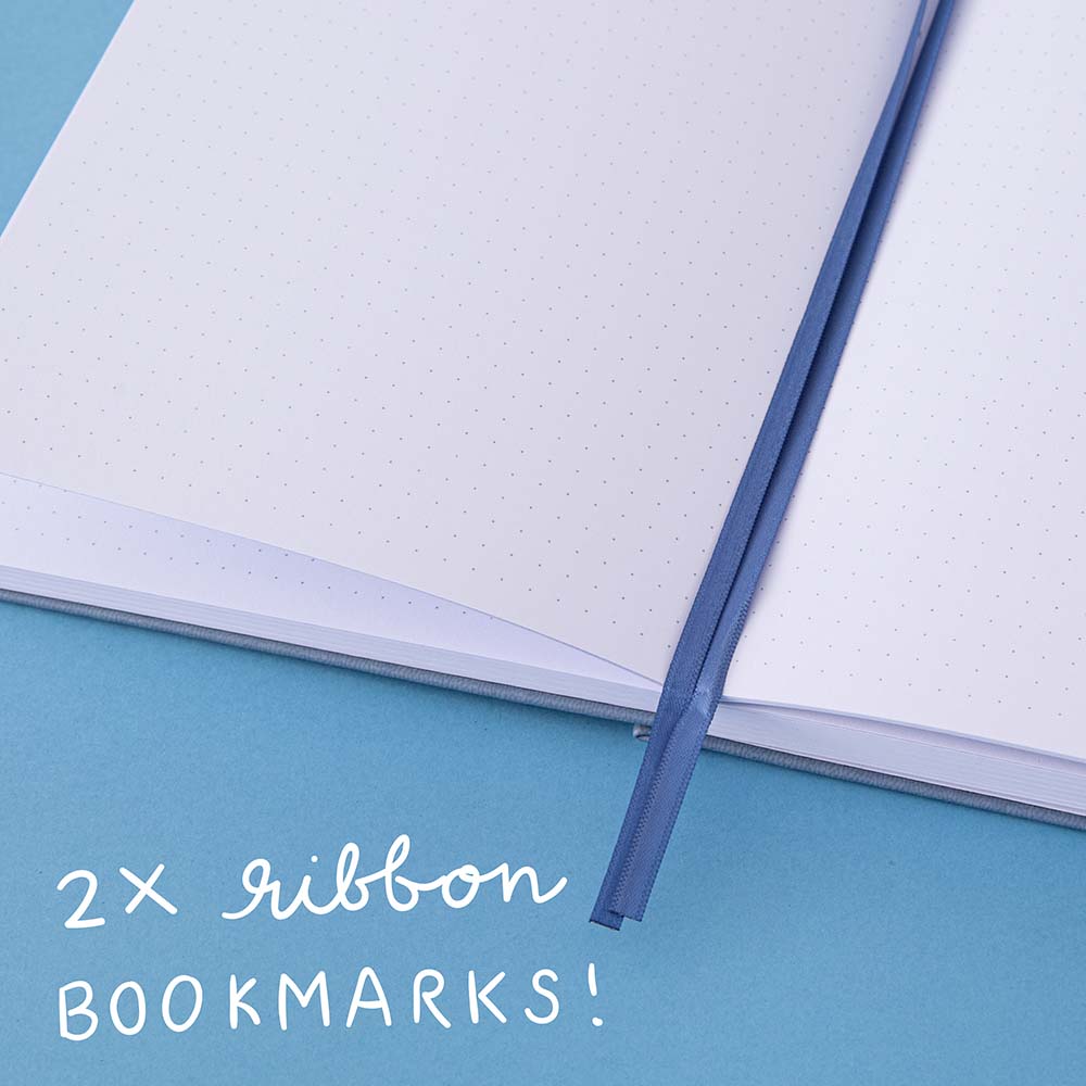 Close up of 2x blue ribbon bookmarks of a bullet journal
