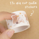 Tsuki Light Academia sticker tape roll close up on brown background with text ‘17x die cut cute stickers’ in white