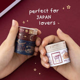 Hands holding Tsuki Torii washi tapes by notebook therapy and “perfect for Japan lovers” written in white