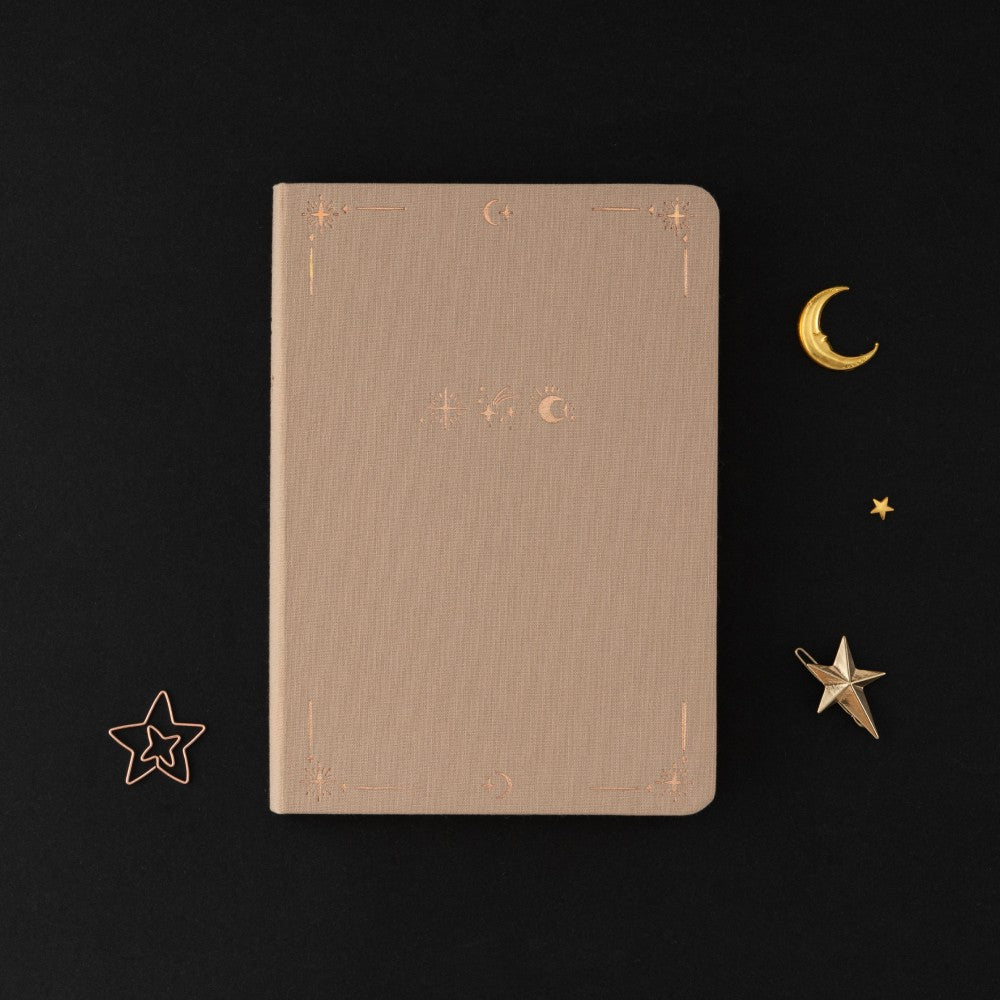 Tsuki Stardust Dawn Bullet Journal with rose gold details and powdered lilac linen on black background 