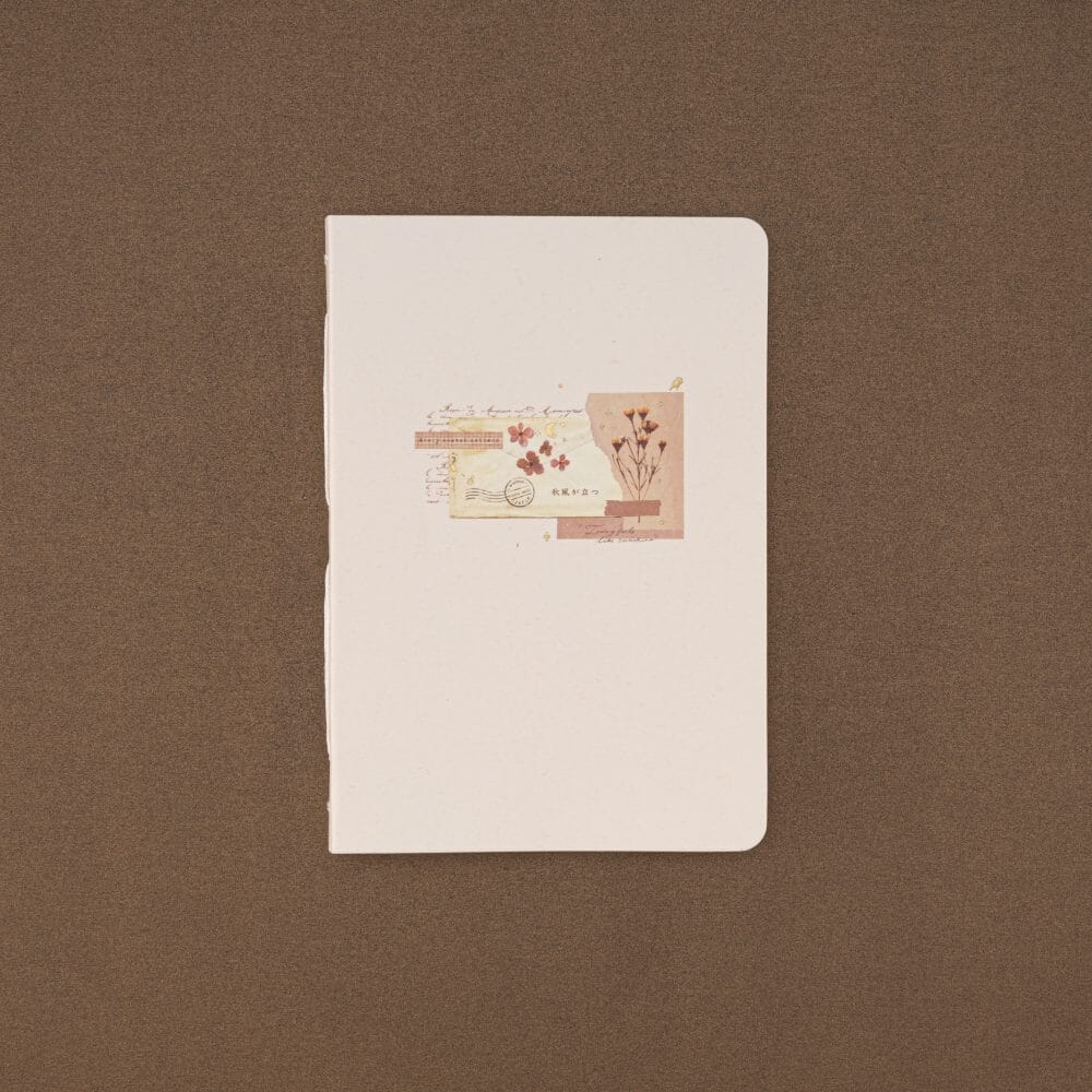 Tsuki Junk Journal notebook by Notebook Therapy on a brown background