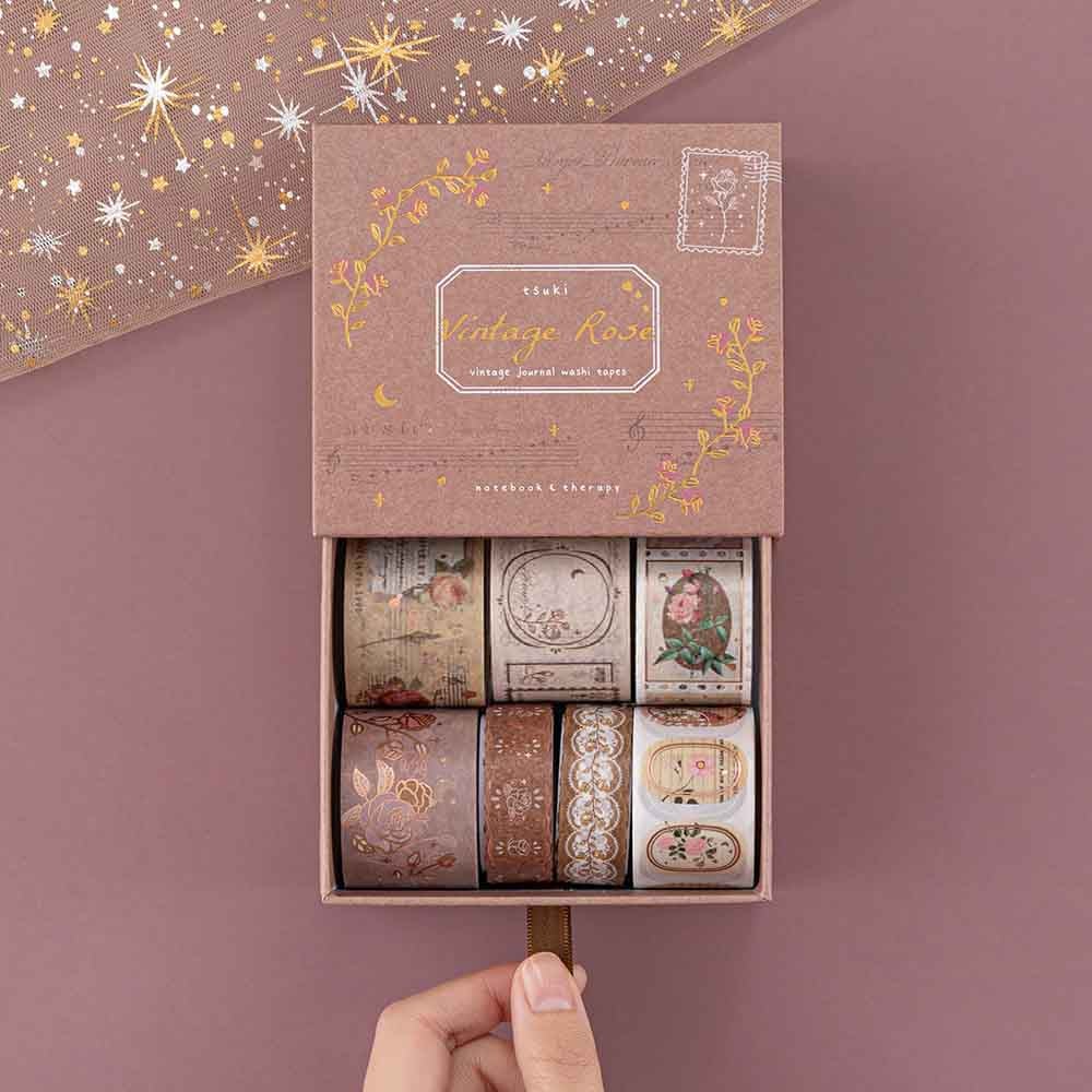 Tsuki ‘Vintage Rose’ Washi Tape Set opened with hand with sparkly netting on mauve background