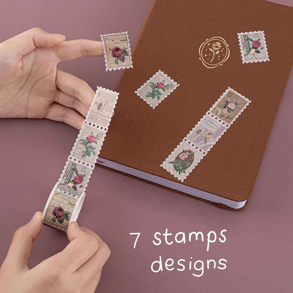Tsuki ‘Vintage Rose’ Stamp Washi Tape with seven stamp designs held in hands with Tsuki ‘Vintage Rose’ Limited Edition Bullet Journal on mauve background