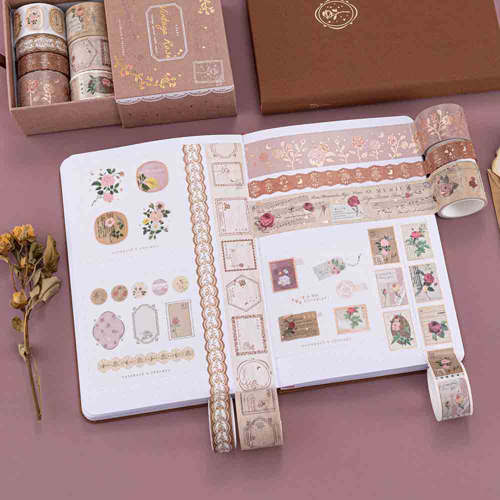 Tsuki ‘Vintage Rose’ Washi Tape Set rolled out on Tsuki ‘Vintage Rose’ Limited Edition Bullet Journal with dried flowers on mauve background