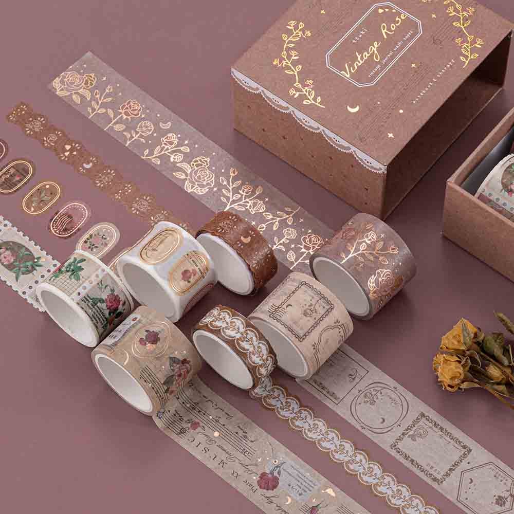Tsuki ‘Vintage Rose’ Washi Tape Set rolled out with dried roses on mauve background