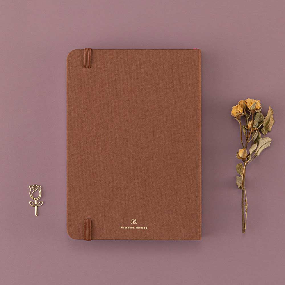 Back cover of Tsuki ‘Vintage Rose’ Limited Edition Bullet Journal with dried roses and free rose paperclip gift on mauve background