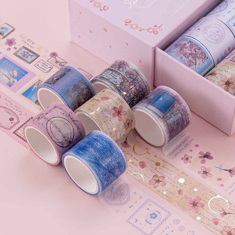 Close up of Tsuki ‘Sakura Journey’ Vintage Journal Washi Tape Set rolled out on pink background