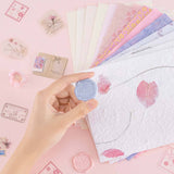Tsuki ‘Sakura Journey’ Scrapbooking Set held in hands on pink background