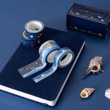 Ocean-themed washi tape rolls on a deep blue velvet bullet journal notebook 