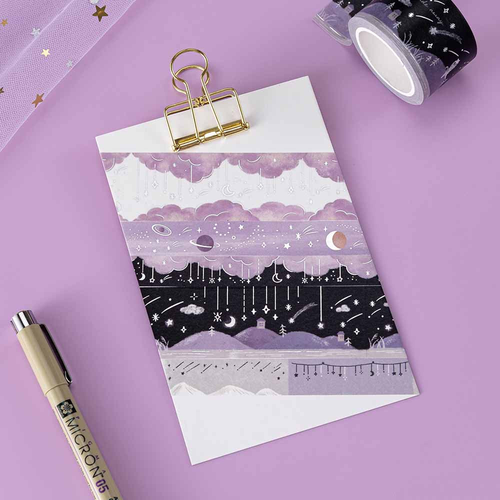Tsuki ‘Falling Star’ Washi Tape Set rolled out on clipboard with pen and sparkl netting on purple background