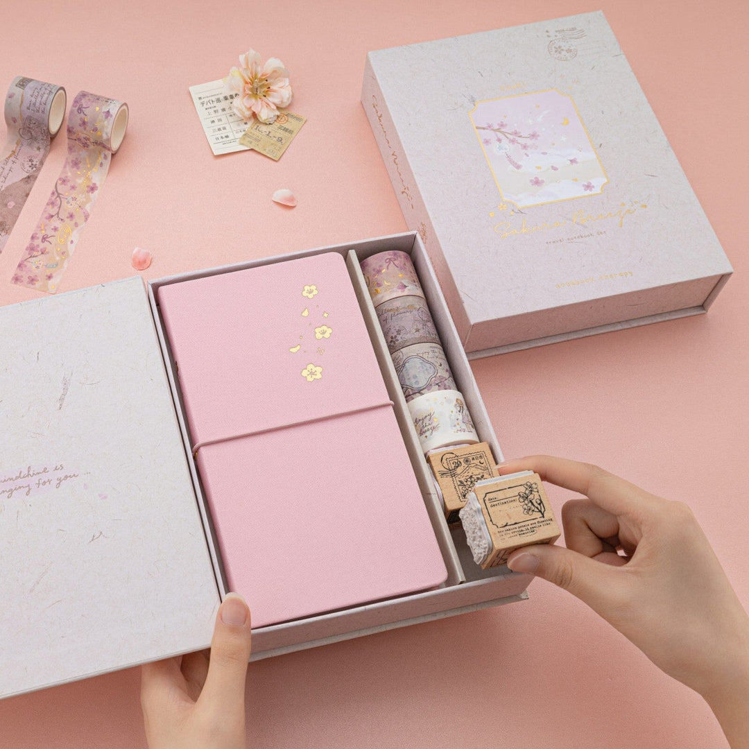 Hand taking out dice stamp from Sakura Beeze travel notebook gift set