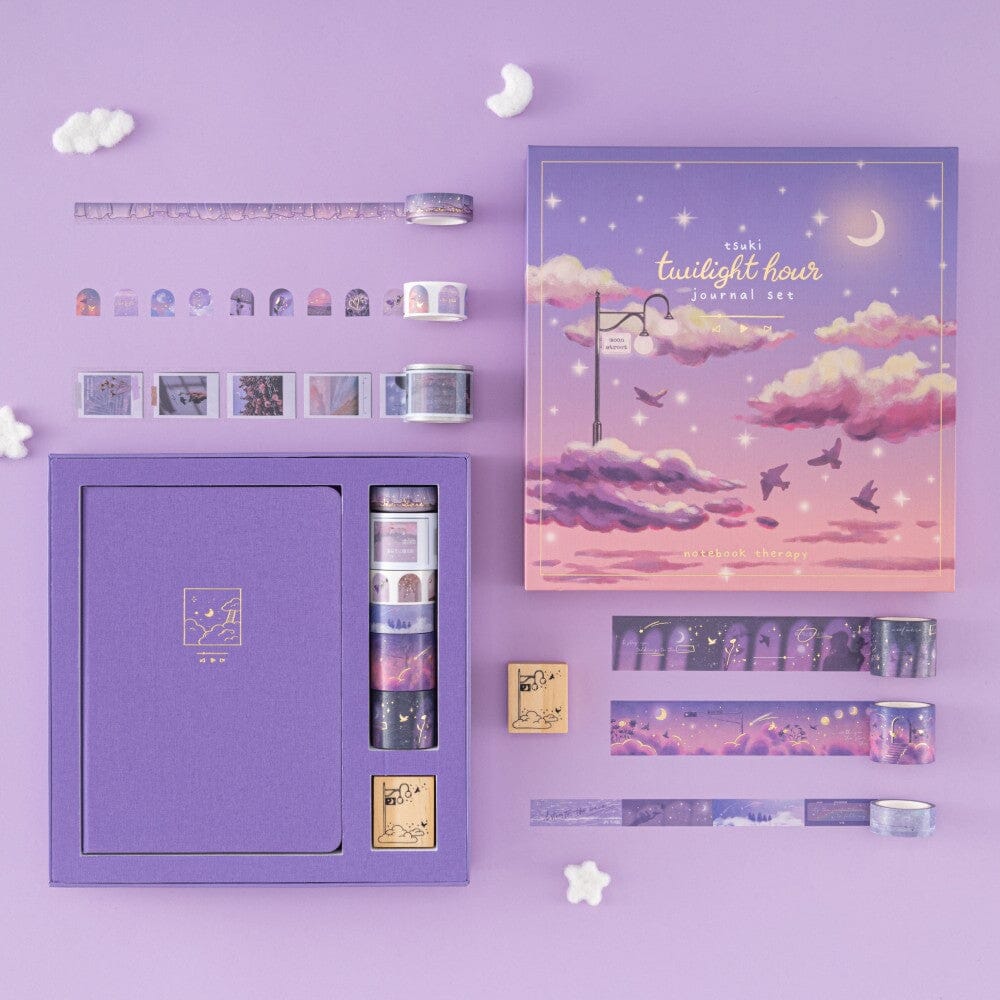 Flatlay of opened Tsuki Twilight Hour Bullet Journlaa set box containing purple bullet journal, 6x washi tapes and 1x wooden stamp