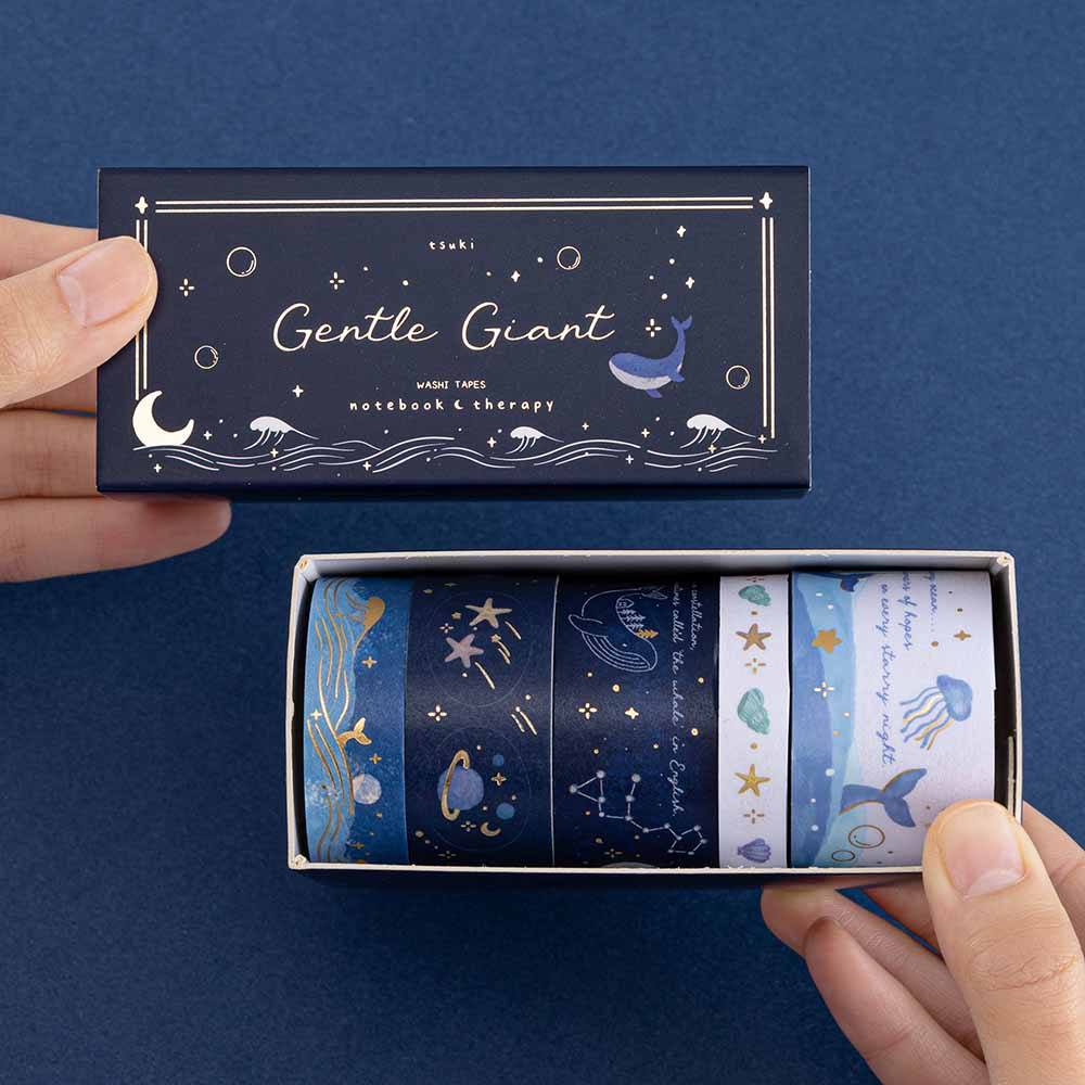 Hands holding an opened box of ocean-themed gentle giant washi tapes
