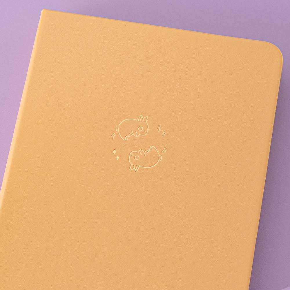 Close up of front cover of Tsuki Honey Butter ‘Bunny Blush’ Limited Edition Bullet Journal designed with Blossom Bujo on lilac background