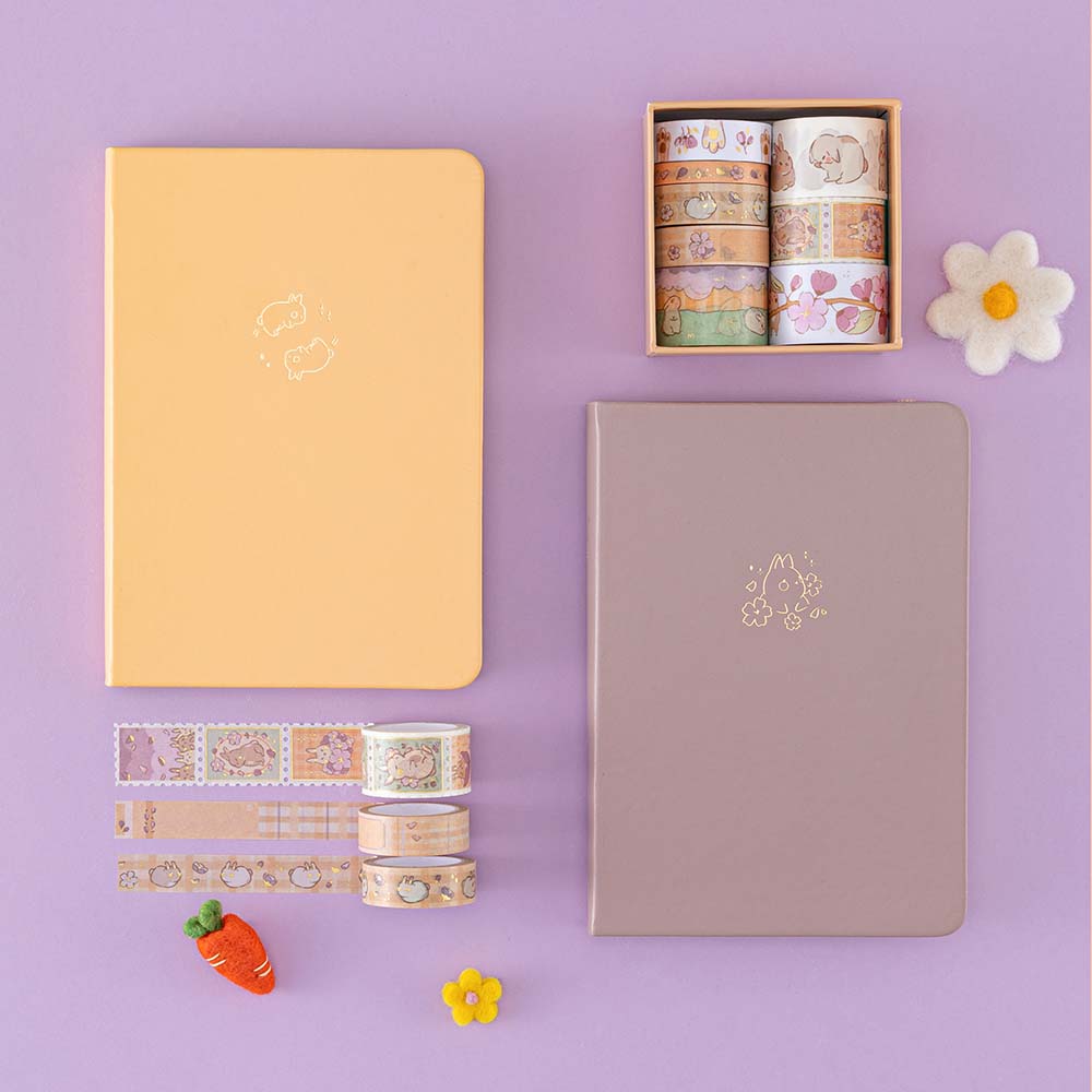 Tsuki Bunny Blush Washi Tape Set designed with Blossom Bujo with Tsuki Honey Butter ‘Bunny Blush’ Limited Edition Bullet Journal and Tsuki Blush Pink ‘Bunny Blush’ Limited Edition Bullet Journal with felt flowers and carrot on lilac background