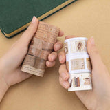 A pair of hands holding Tsuki Light Academia Washi Tape Set rolls with a green velvet bullet journal in the background
