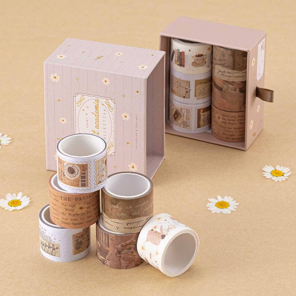 Tsuki Light Academia washi tape rolls stacked in a pyramid with the open drawer box in the background