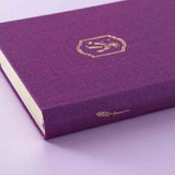 Tsuki ‘Enchanted Garden’ lavender foil design on purple linen bullet journal on purple background 