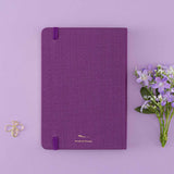 Tsuki ‘Enchanted Garden’ back cover on purple linen bullet journal on purple background