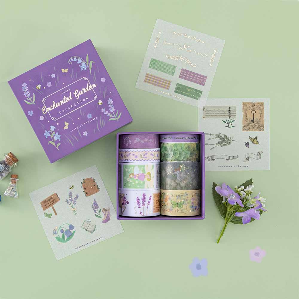 Tsuki ‘Enchanted Garden’ Washi Tape Set open box on sage green background with purple flower decoration
