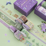 Tsuki ‘Enchanted Garden’ Washi Tape Set rolls on sage green background with purple flower decoration