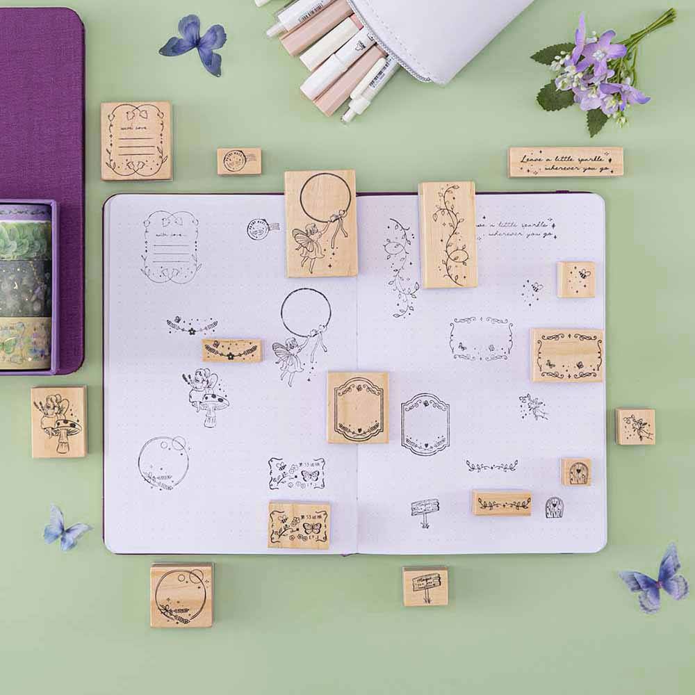 Tsuki ‘Enchanted Garden’ Stamp Set on dotted notebook and sage green background with purple flower decoration